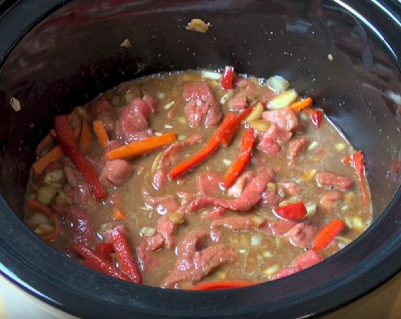 step 2 Place each piece of theBeef Steak (2.2 lb) into Corn Flour (1/2 cup) and place it on a plate. Add into the slow cooker and stir until all the meat is covered. Cover and cook on high for 2 hours.