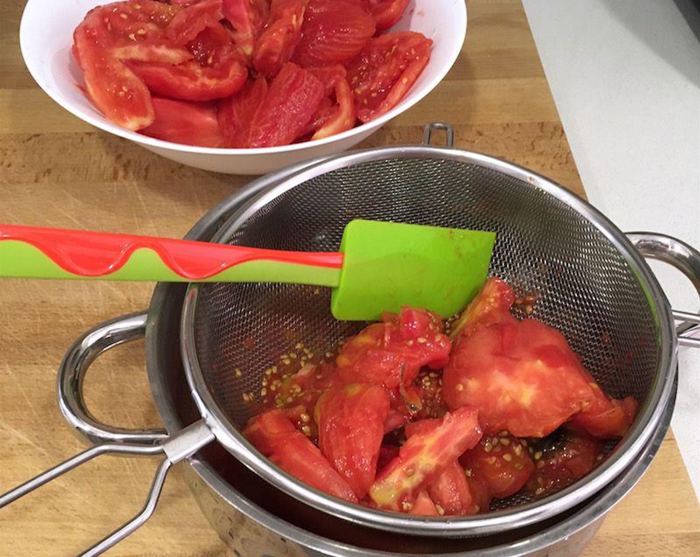 step 4 Press the reserved cores and seed pulp gently in a sieve to collect juice. Use the collected juice to soak the bread pieces and discard the remaining seeds and pulp.