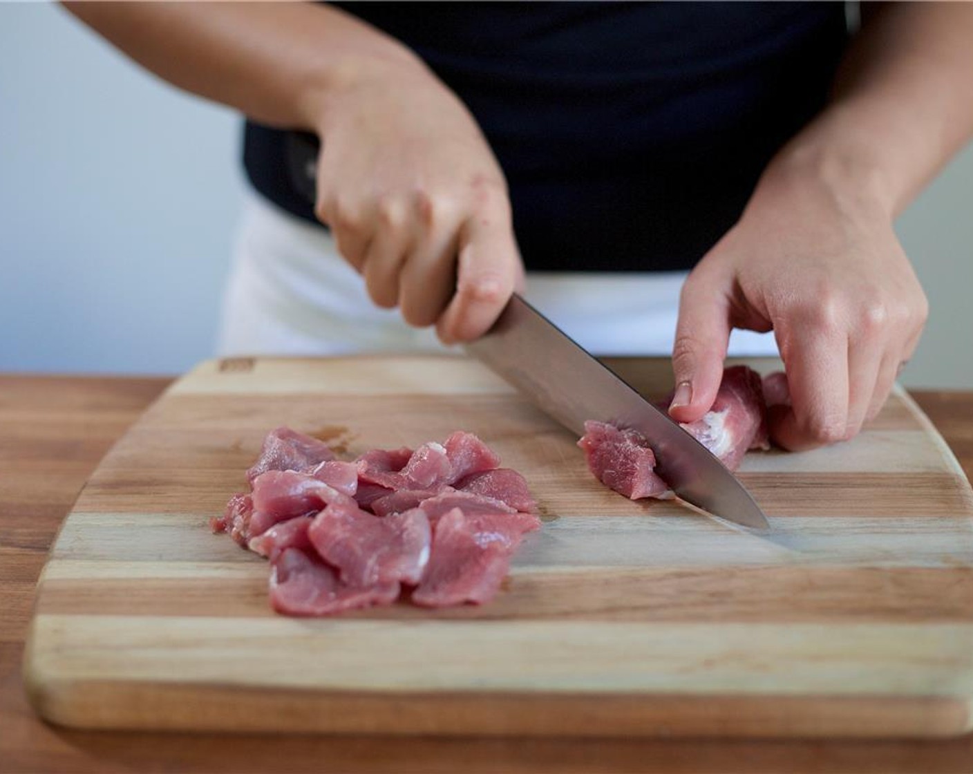 step 5 Pat dry Pork Tenderloin (8 oz) with paper towels. Slice the pork tenderloin in half lengthwise and then across into quarter inch strips. Place in a second small bowl. Season the pork with Salt (1/4 tsp) and Ground Black Pepper (1/4 tsp). Set aside.