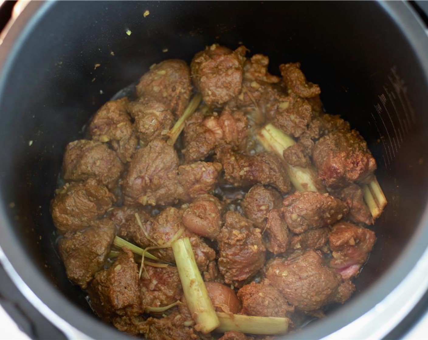 step 6 In the meantime, peel and remove the seeds from the tomatoes, catch the juices and crush the flesh with your hands in a bowl and set aside. Add the beef mixture to the cooker and brown.