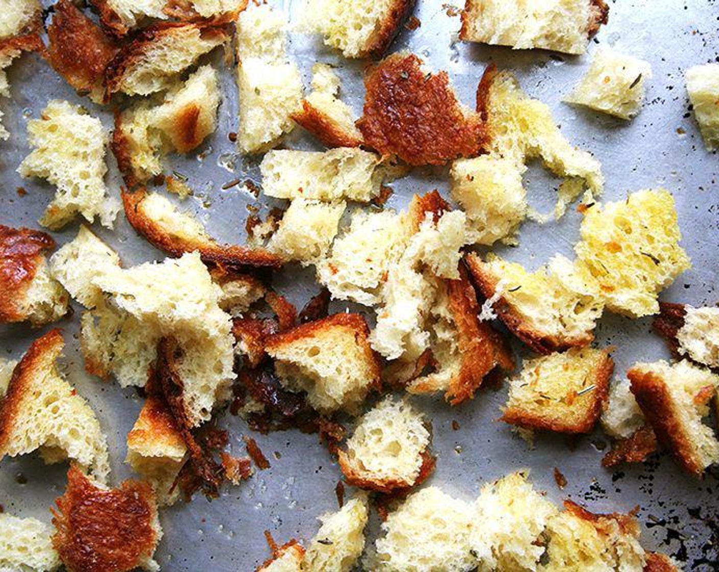 step 3 Spread the bread evenly on a baking sheet and bake until golden brown and crisp, about 15 minutes. Midway through baking, redistribute the croutons if they are coloring unevenly.