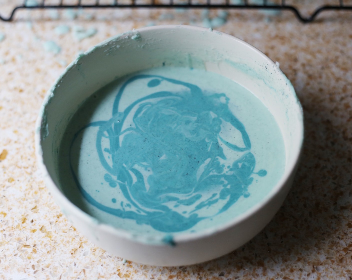 step 9 You might need to melt the chocolate again, which will allow you to tint half of it a darker shade of blue. Use this to coat dip the patties again to obtain a marble effect.