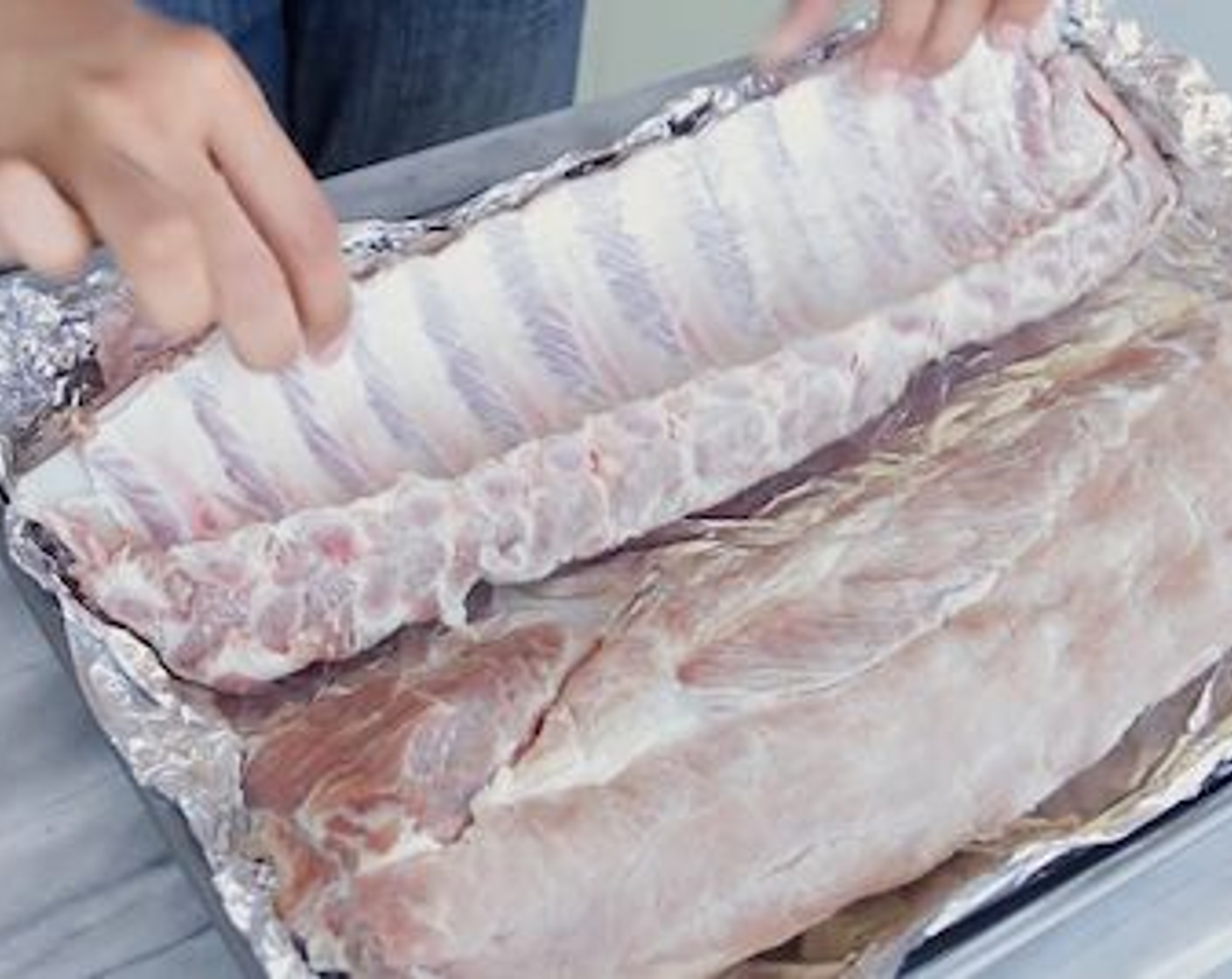 step 3 Peel off the tough membrane that covers the bony side of the Pork Baby Back Ribs (4 lb), remove excess fat,  then rinse really well. Place on a baking sheet or tray lined with foil.