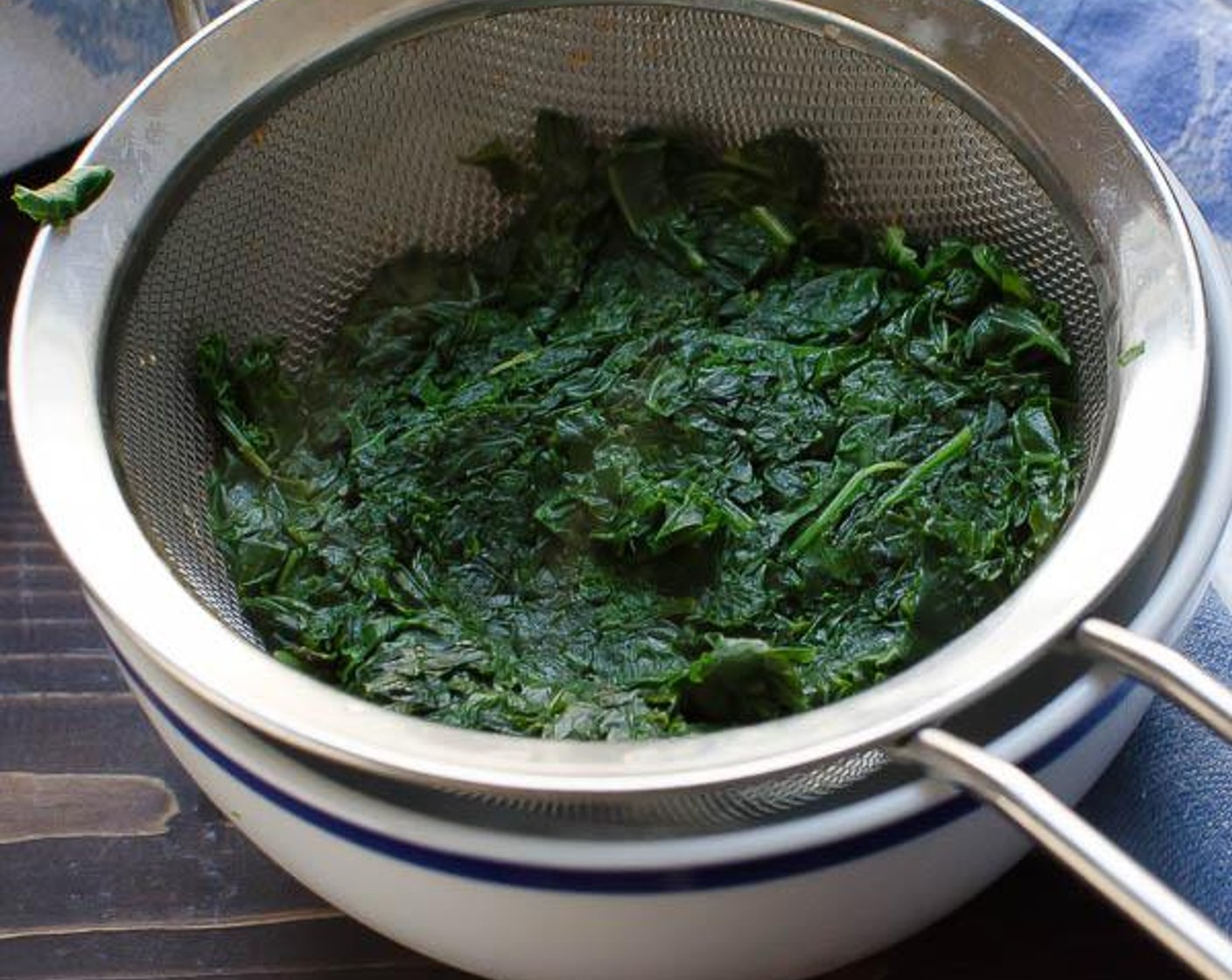 step 4 Steam the kale for 2 to 3 minutes until wilted, but still bright green. Transfer the kale to a fine mesh sieve and press on the kale with the back of a spoon to squeeze out all of the excess water and set aside.