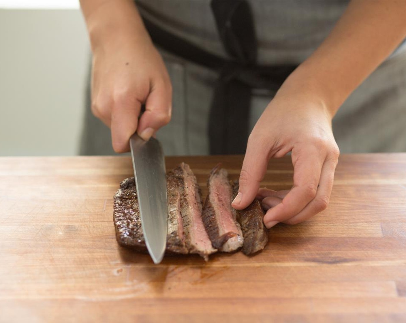 step 15 Remove the steak from the foil and cut into thin slices against the grain. Set aside.