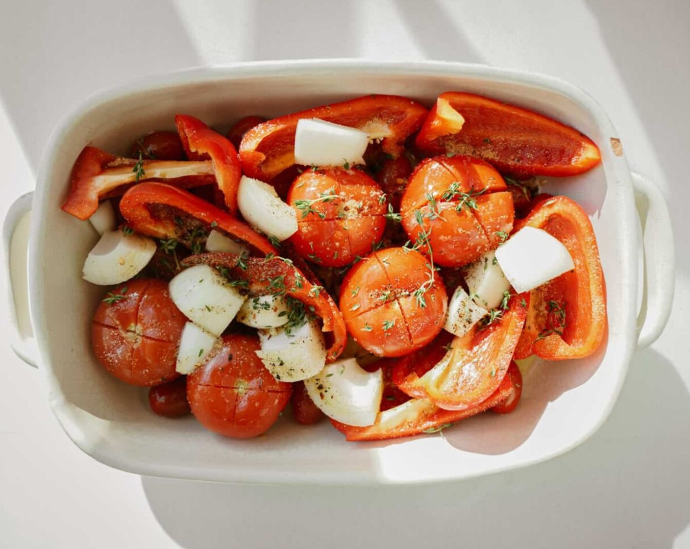 step 2 To a sheet pan or roasting pan add Red Bell Peppers (2), Tomatoes (5), White Onion (1), Garlic (4 cloves), Fresh Thyme (2 Tbsp), Olive Oil (3 Tbsp), Sea Salt (1 tsp), and Ground Black Pepper (1/2 tsp). Cook for 40 minutes or until perfectly golden and roasted.