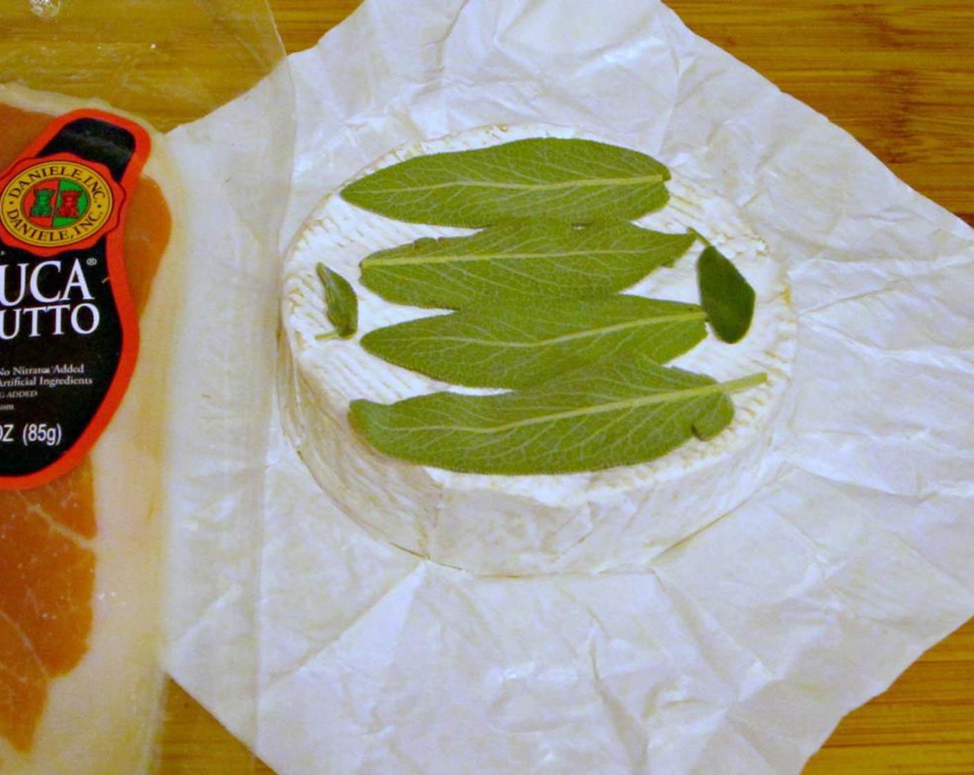 step 3 Place sage leaves on top of brie.