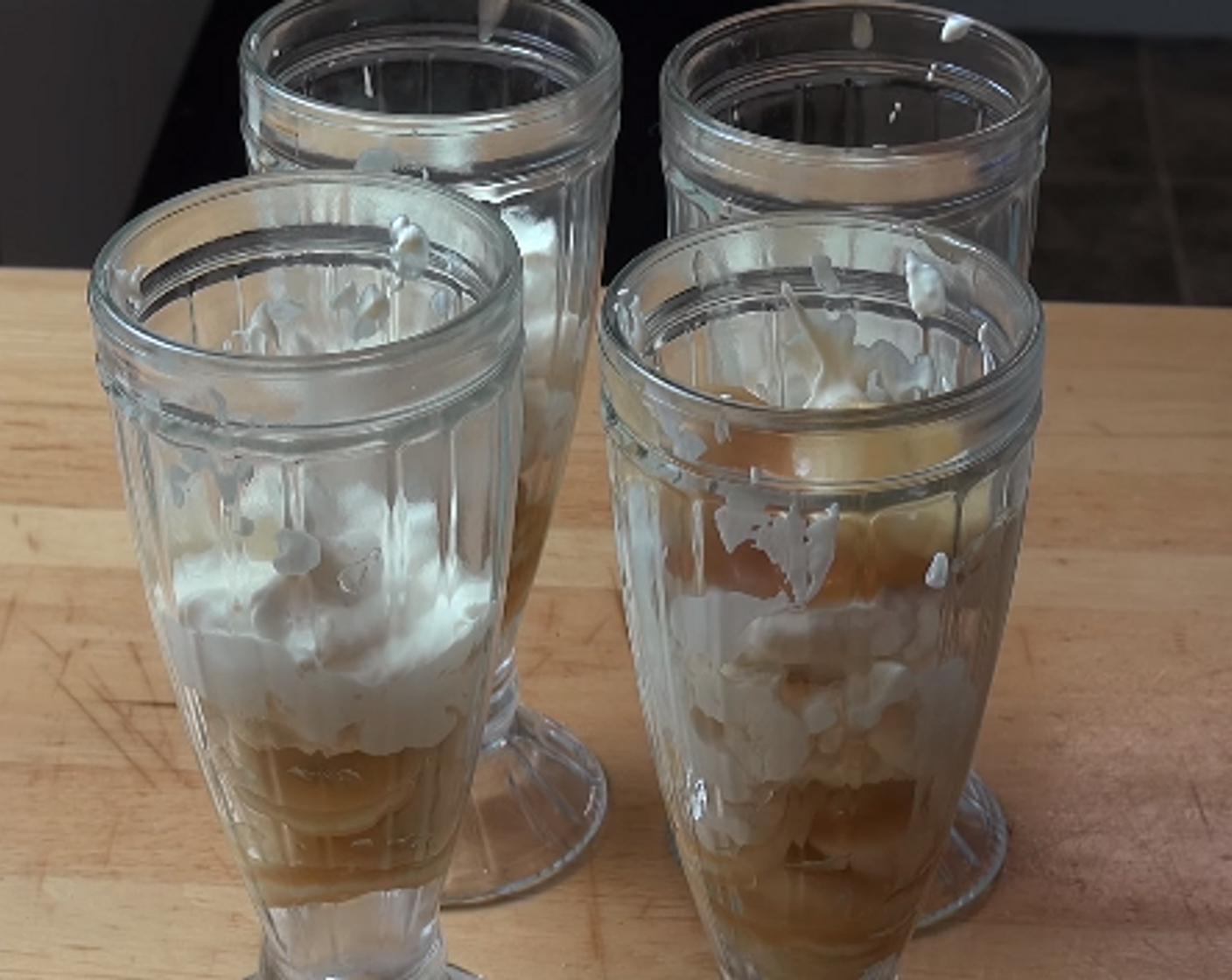 step 3 Divide half the banana mixture between four serving glasses, followed by half of the cream-meringue mixture. Repeat with the rest of the banana and meringue mixtures.