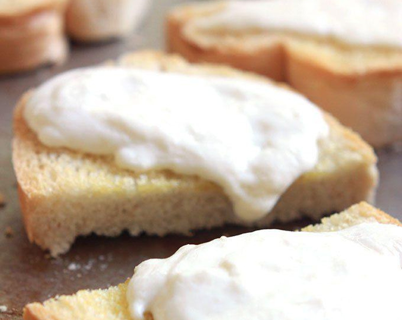 step 5 Remove from oven, slice Burrata Cheese (3 cups), and place on toast. Return toast to the oven and heat until cheese just starts to melt.