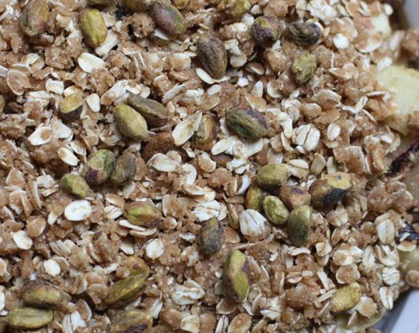 step 6 Transfer apples and plums to baking dish and spread evenly. Scatter topping over fruit. Sprinkle Pistachios (1/3 cup) evenly over topping.