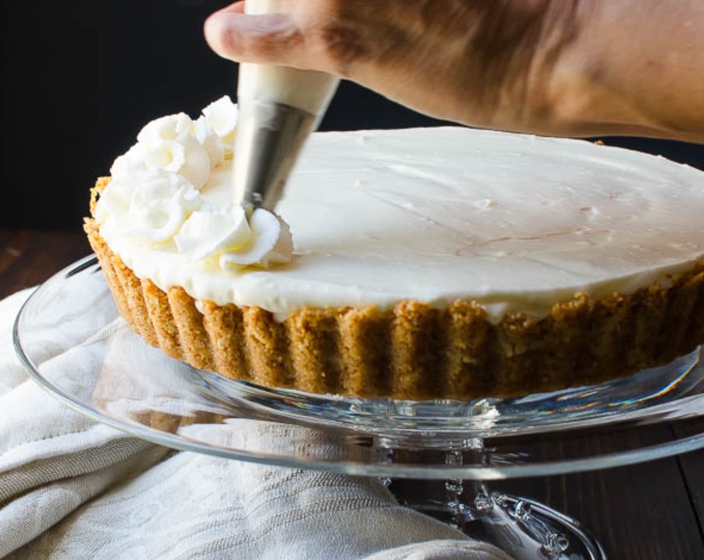 step 11 Add reserved Whipped Cream (1 cup) to a piping bag fitted with a large star tip. Fold the end of the bag over once or twice to seal and use a steady pressure to pipe the whipped cream around the edge of the tart and in the center.