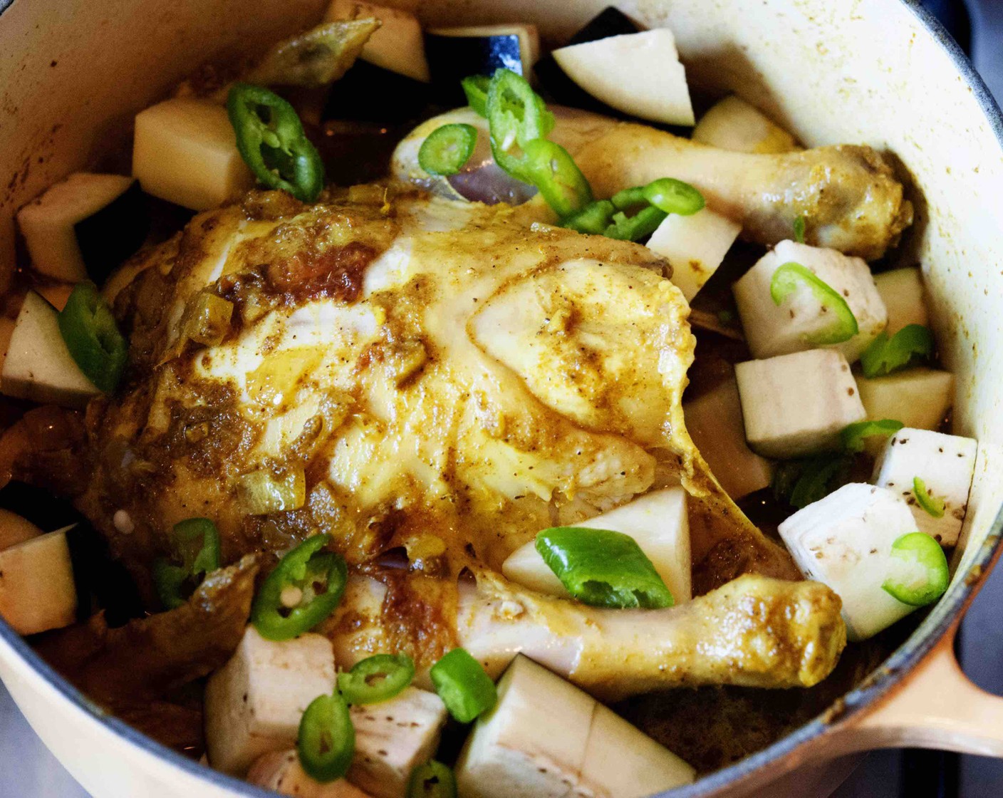 step 13 Add half of the potato, eggplant, green chili, and Water (1/2 cup). Cover with a lid and cook on low heat for 25 min, turning the chicken after 15 min.