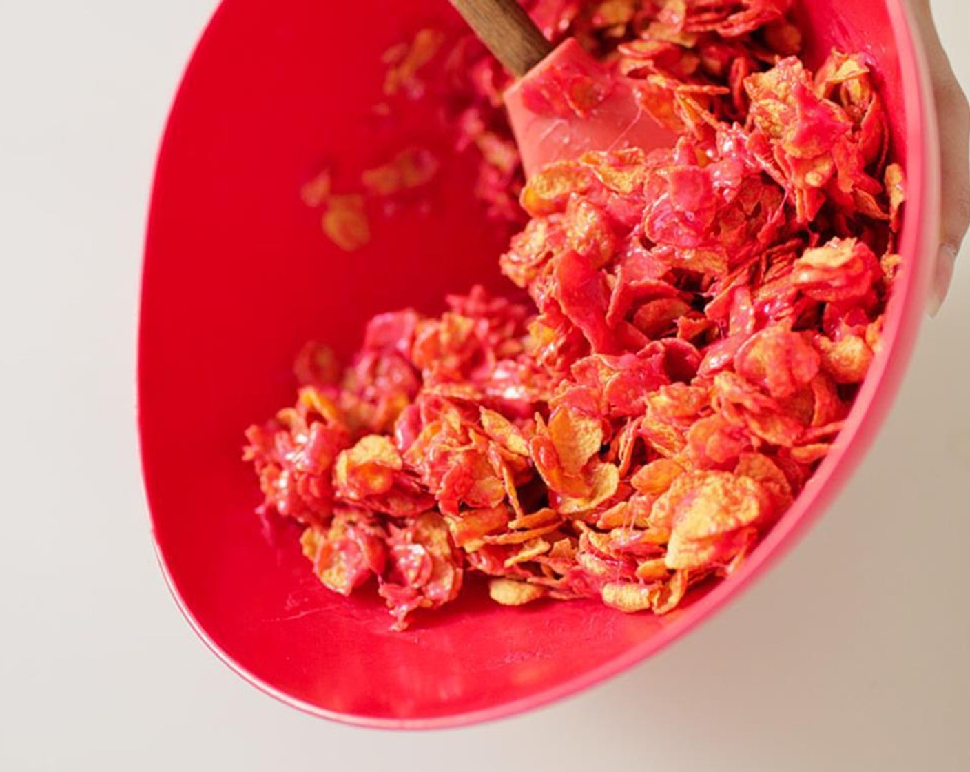 step 2 Remove marshmallows from heat and stir in Red Food Coloring (1/2 tsp). In a large mixing bowl, mix marshmallows and Corn Flakes (6 cups) together.