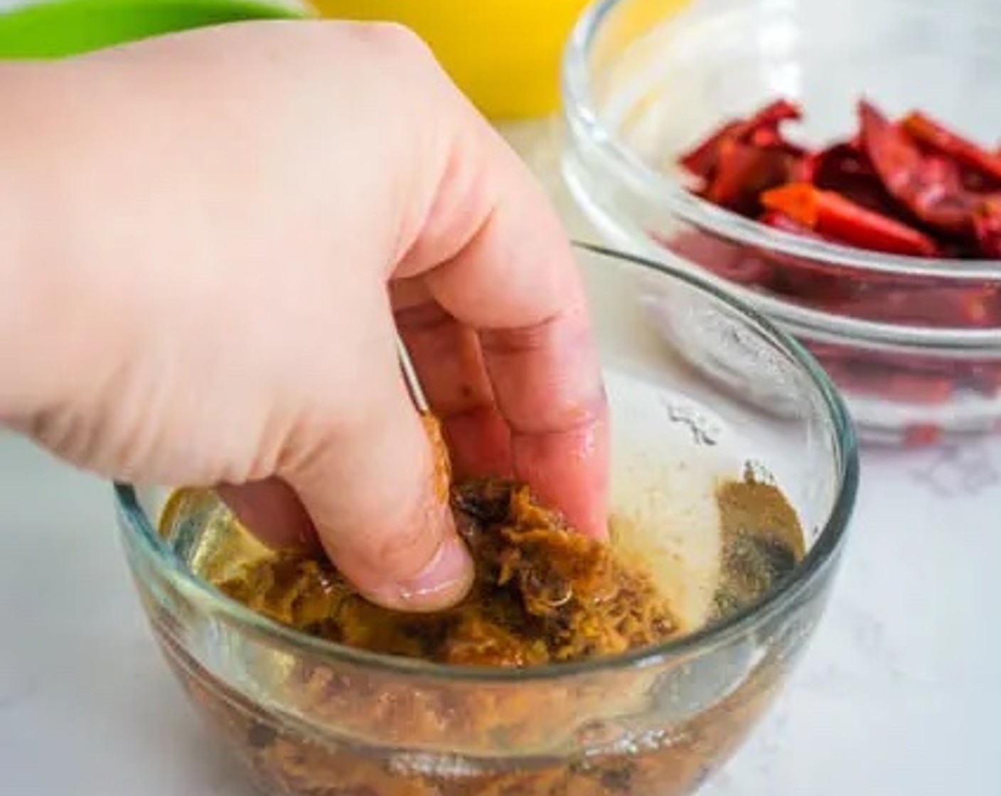 step 3 Gently squeeze the tamarind pulp with your fingers to draw out as much of the tamarind juice as possible. Discard the tamarind pulp and seeds.