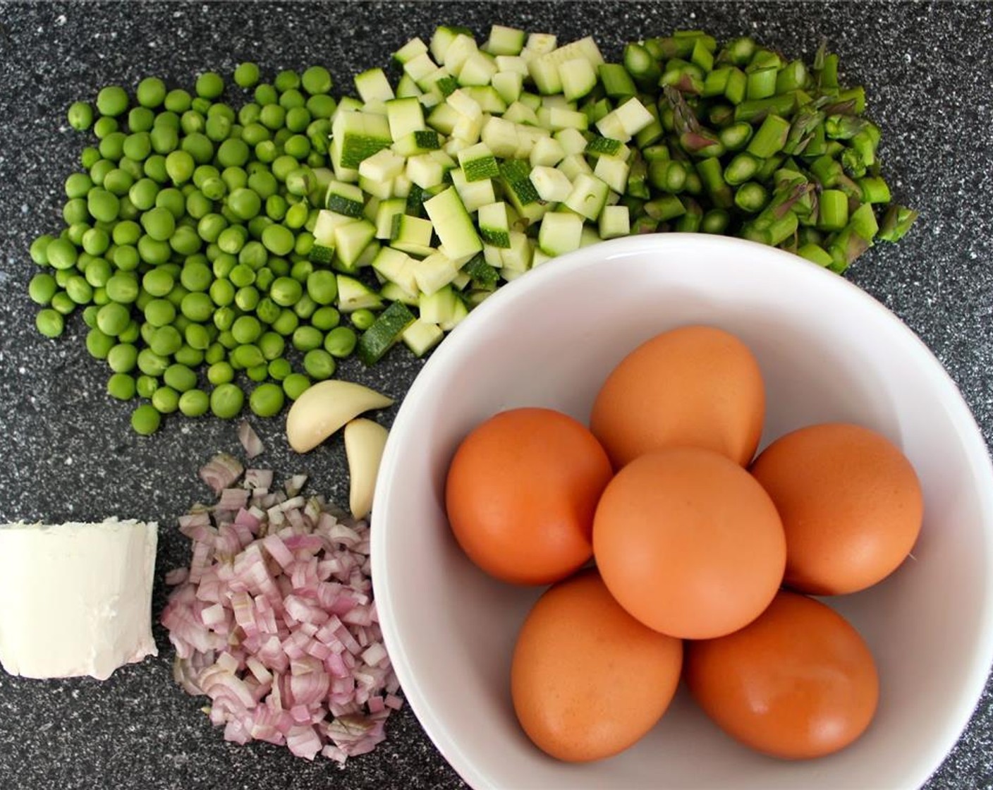 step 1 Prep your ingredients: crumble the Goat Cheese (3 2/3 Tbsp), chop the Zucchini (3/4 cup), slice the Asparagus (10) diagonally into 1/2 inch pieces, chop the Shallot (1), and mince the Garlic (2 cloves).