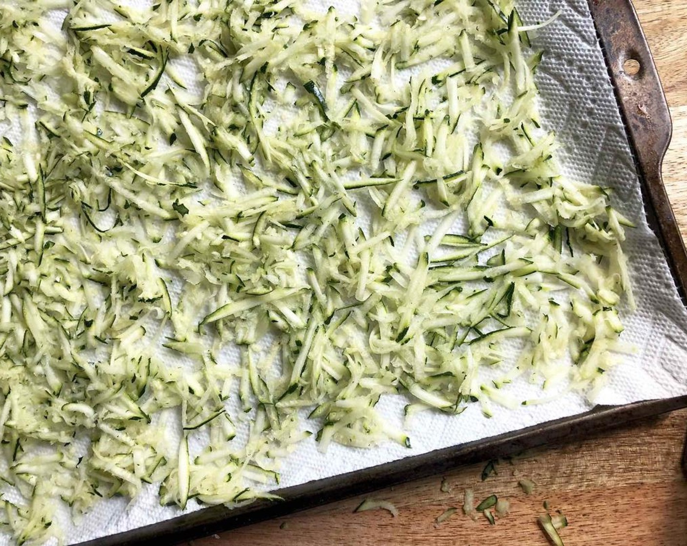 step 1 Line a 15 x 10 x 1-inch baking pan with several layers of paper towels. Spread Zucchini (1 3/4 cups) on paper towels and sprinkle with Salt (1/2 tsp). Top with another layer of paper towels and let stand for 15 minutes, pressing occasionally to release the excess moisture.
