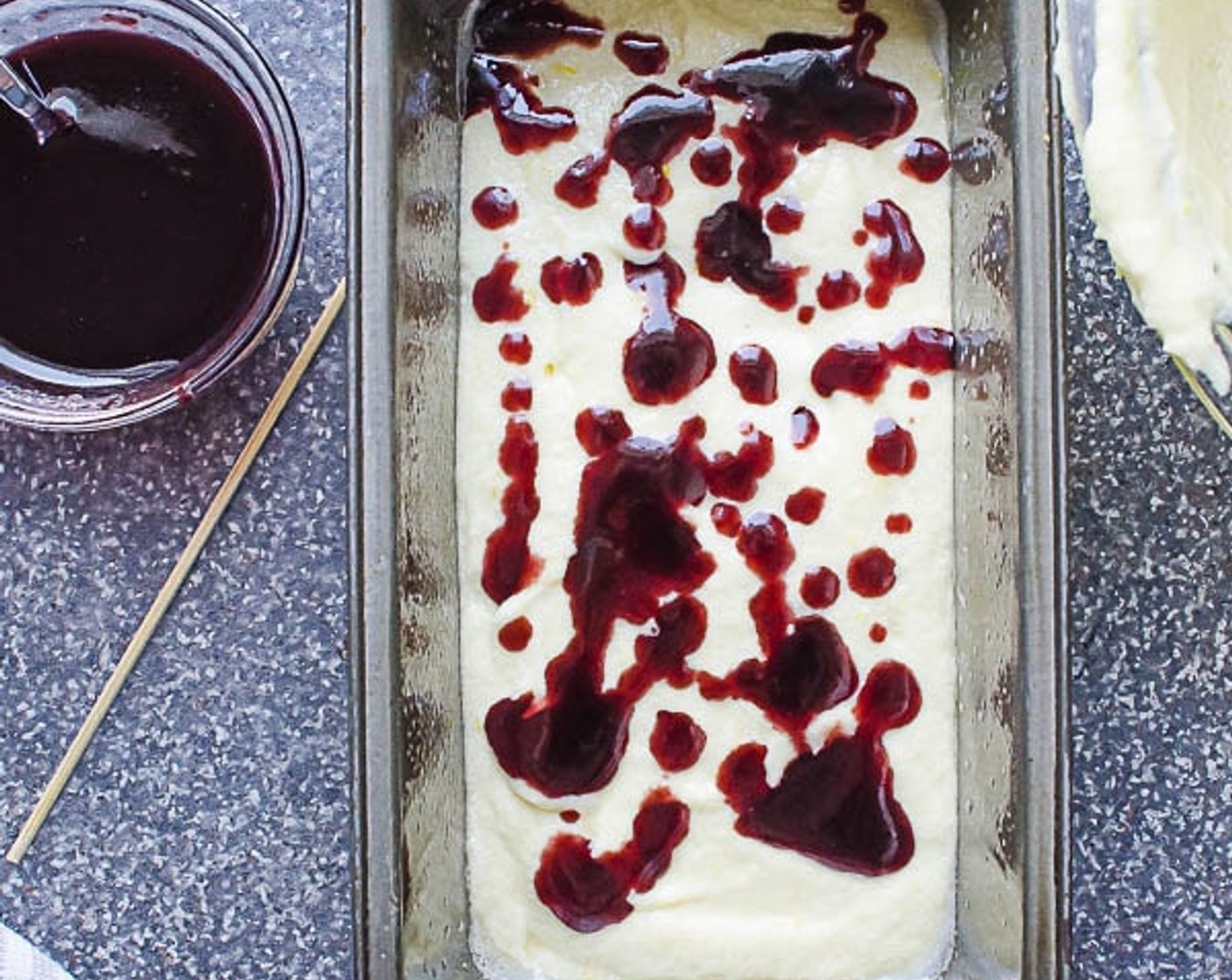 step 7 Add 1/3 of the batter to the prepared loaf pan. Drizzle 1/3 of the blackberry jam over the batter.