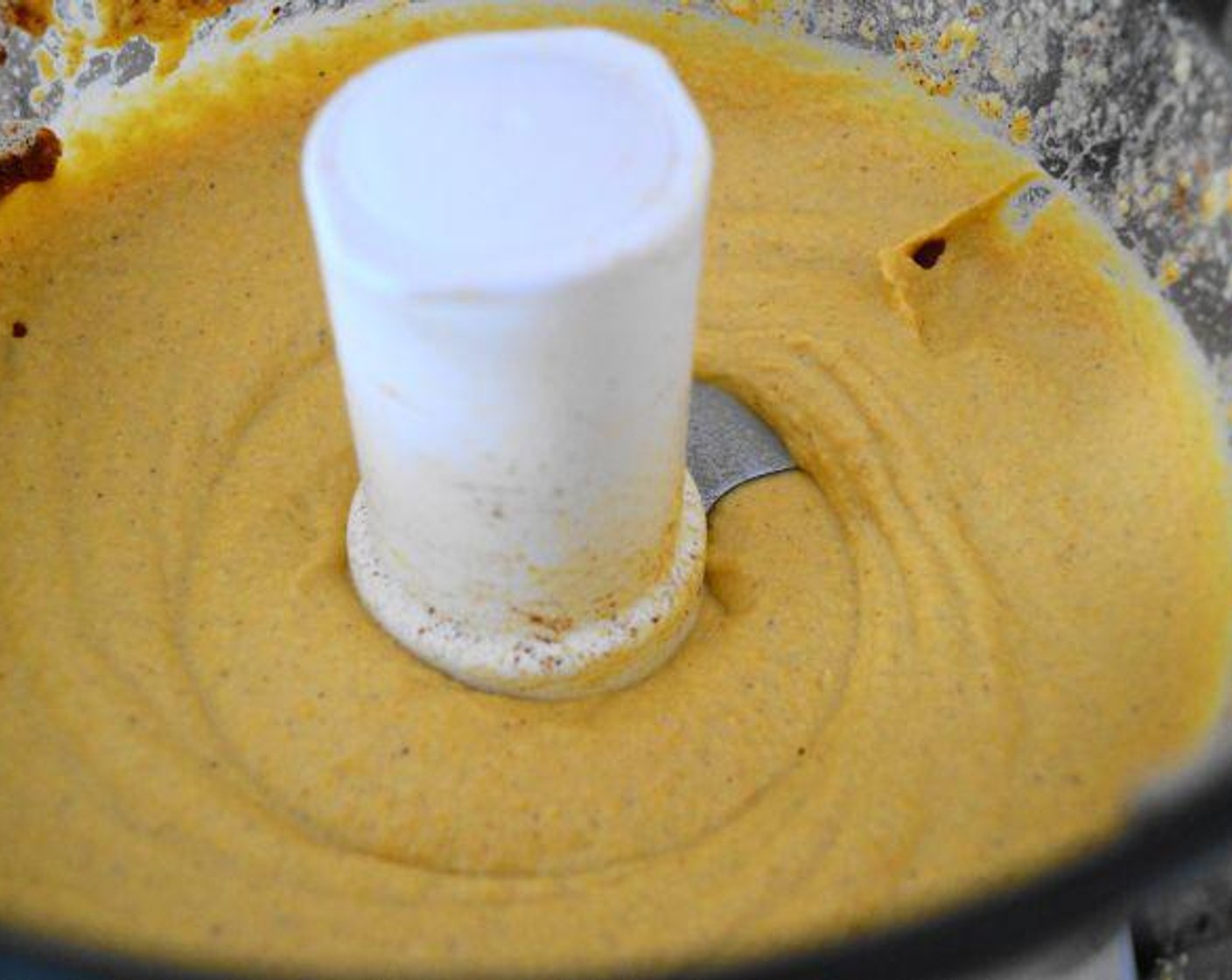step 6 Add the Tahini (4 Tbsp), Garlic (4 cloves), Chickpeas (1 can), zest, and juice of a Lemon (1), and Ground Allspice (1/2 tsp) into the processor with the squash and run it until it becomes a thick puree.