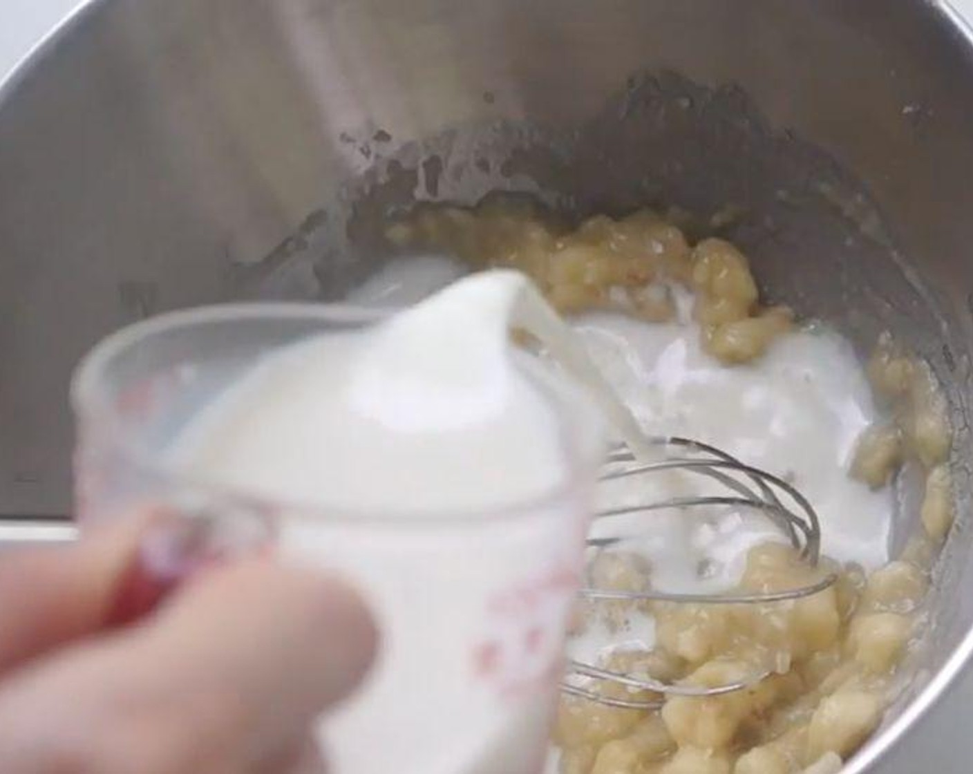 step 3 Add half the portion of Milk (1/3 cup) and the 2 of the egg yolks to a large bowl. Mix well.