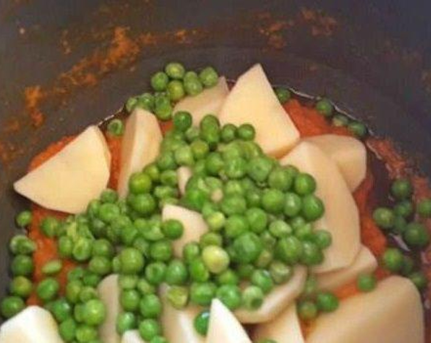 step 4 Add chopped Potatoes (2), Green Peas (1 cup) and Paneer (1 cup). Stir again.