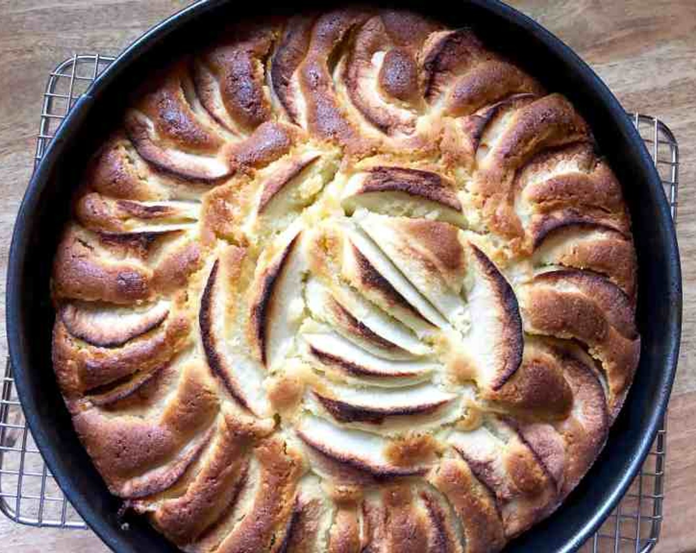 step 10 Place the pan in the oven and bake for 1 hour and 10 minutes, or until the top is golden brown and a tester inserted into the middle of the cake comes out clean. Remove the pan from the oven and place it on a rack to cool.