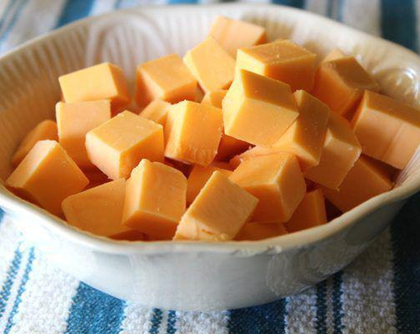 step 2 Cut Extra Sharp Cheddar Cheese (1 1/2 cups) into 1/2 inch cubes.