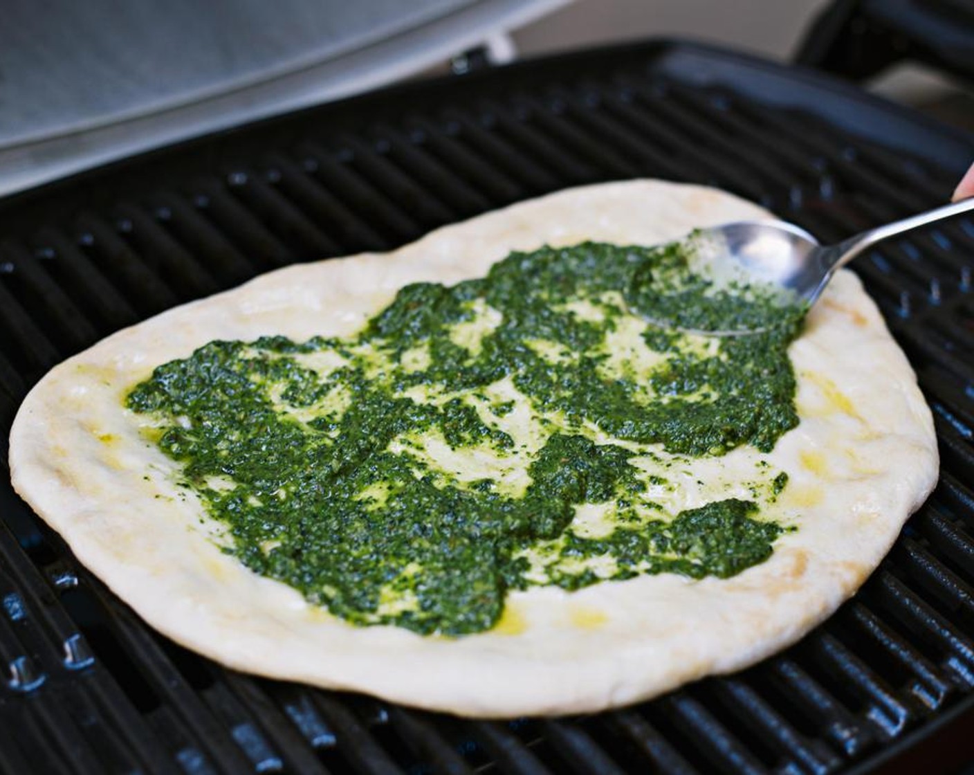 step 5 Brush remaining Extra-Virgin Olive Oil (2 Tbsp) onto top of crust and spread Basil Pesto (1 cup) onto oiled dough.
