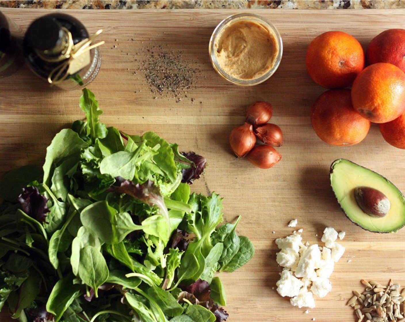 step 5 Add Fresh Spinach (2 handfuls) to a plate and sprinkle place oranges on top of the spinach. Sprinkle with Feta Cheese (1/4 cup) and Salted Sunflower Seed Kernels (1 1/2 Tbsp).