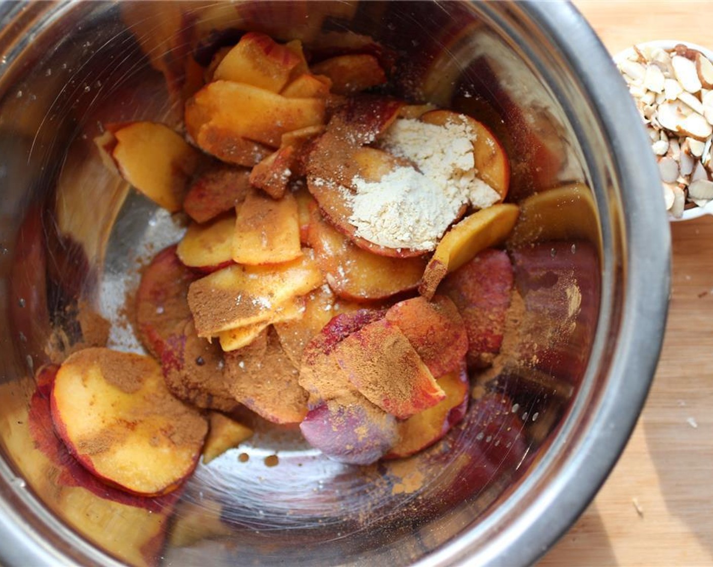 step 3 In a large bowl, add the peaches, Simply Organic Cinnamon, Ground (1/2 tsp), Vanilla Extract (1/2 tsp), Chickpea Flour (1 Tbsp), juice from Lemon (1), Agave Syrup (1 tsp), and Salt (1 pinch). Mix well but ensure the peaches stay intact.