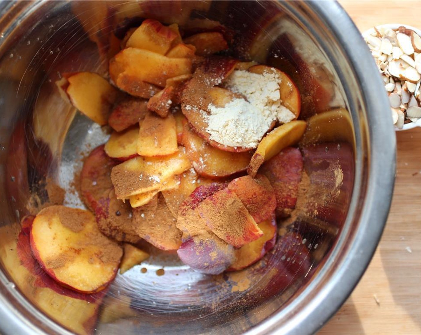 step 3 In a large bowl, add the peaches, Ground Cinnamon (1/2 tsp), Vanilla Extract (1/2 tsp), Chickpea Flour (1 Tbsp), juice from Lemon (1), Agave Syrup (1/2 Tbsp), and Salt (1 pinch). Mix well but ensure the peaches stay intact.