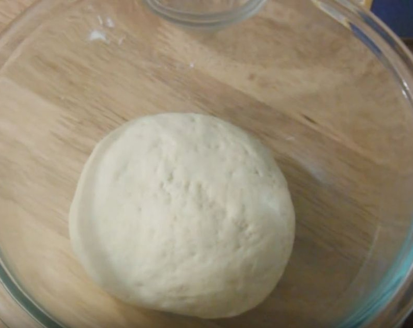 step 2 Transfer dough to a clean bowl and cover with a towel. Let it rise for 15 minutes.
