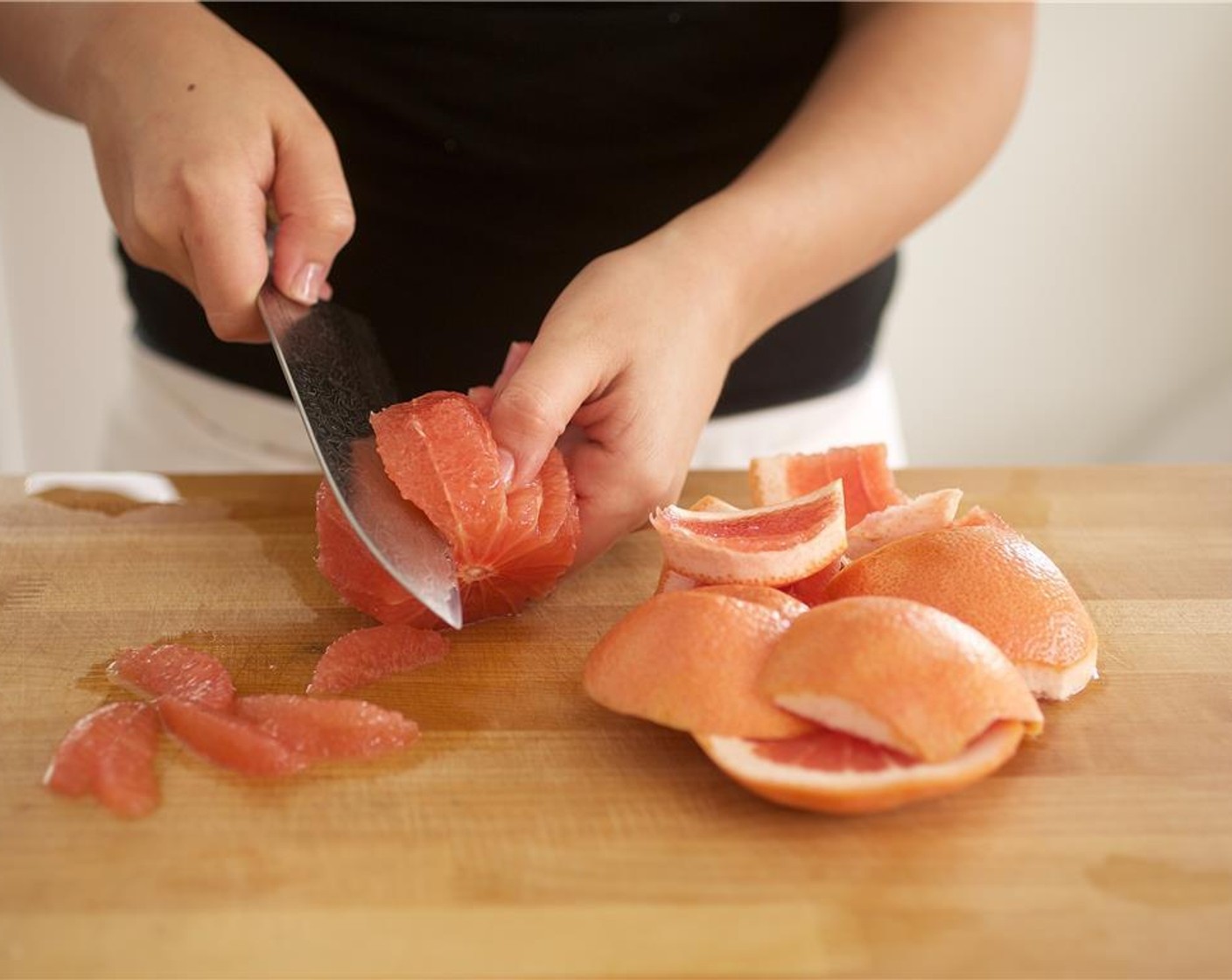 step 2 Slice off the top and bottom of the Grapefruit (1) and discard. Using even, downward strokes, slice the rind away from the flesh and discard the rind. Remove any remaining white pith and cut between the membranes to segment the fruit. Cut into half inch pieces and add to bowl.