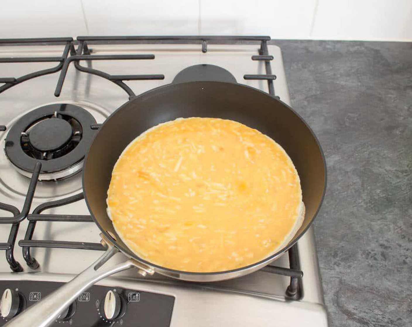 step 2 Heat a large non-stick frying pan over medium heat. When the pan is hot, pour in the egg mixture.
