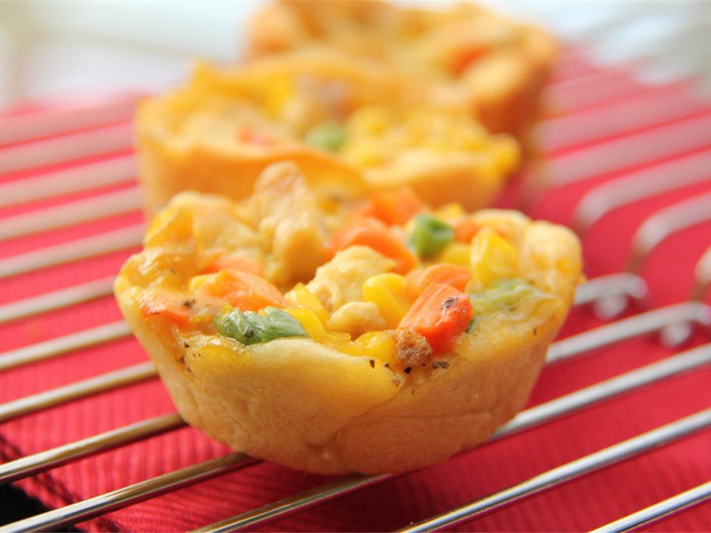 Step 4 of Muffin Tin Pot Pie Recipe: Bake for 15 minutes or until golden brown. Let cool on cookie sheet for 3 to 5 minutes.