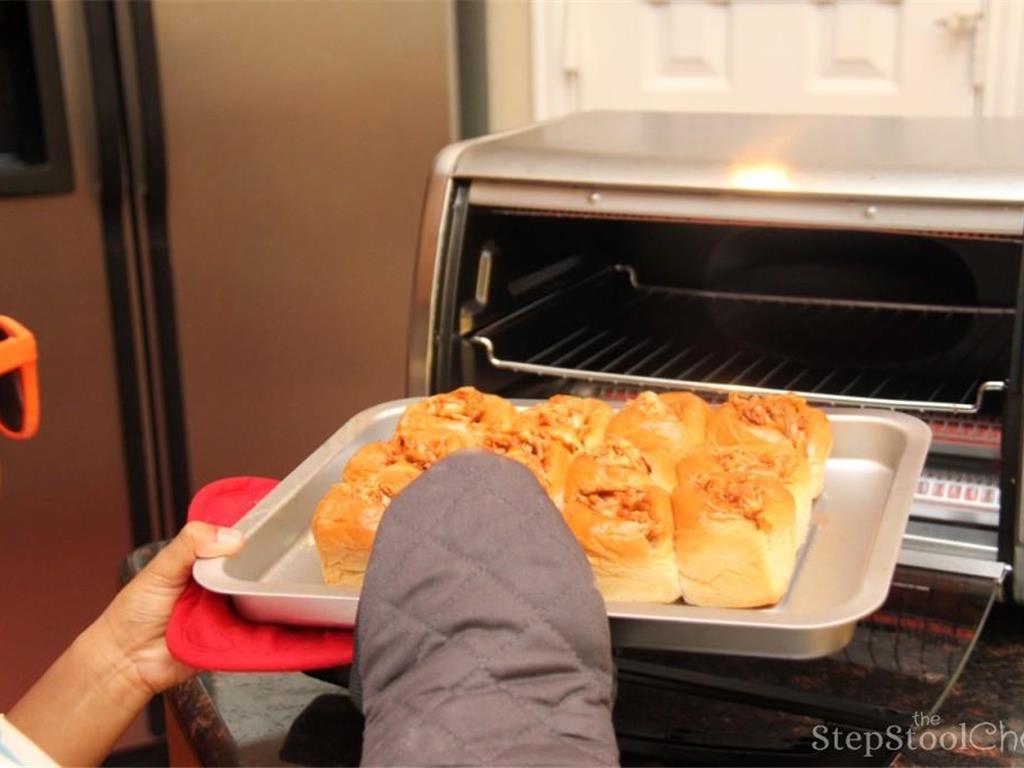 Step 5 of Pull Apart BBQ Chicken Sliders Recipe: Place in toaster oven or regular oven at 350 degrees F (180 degrees C) for approximately 5 minutes or until warm.