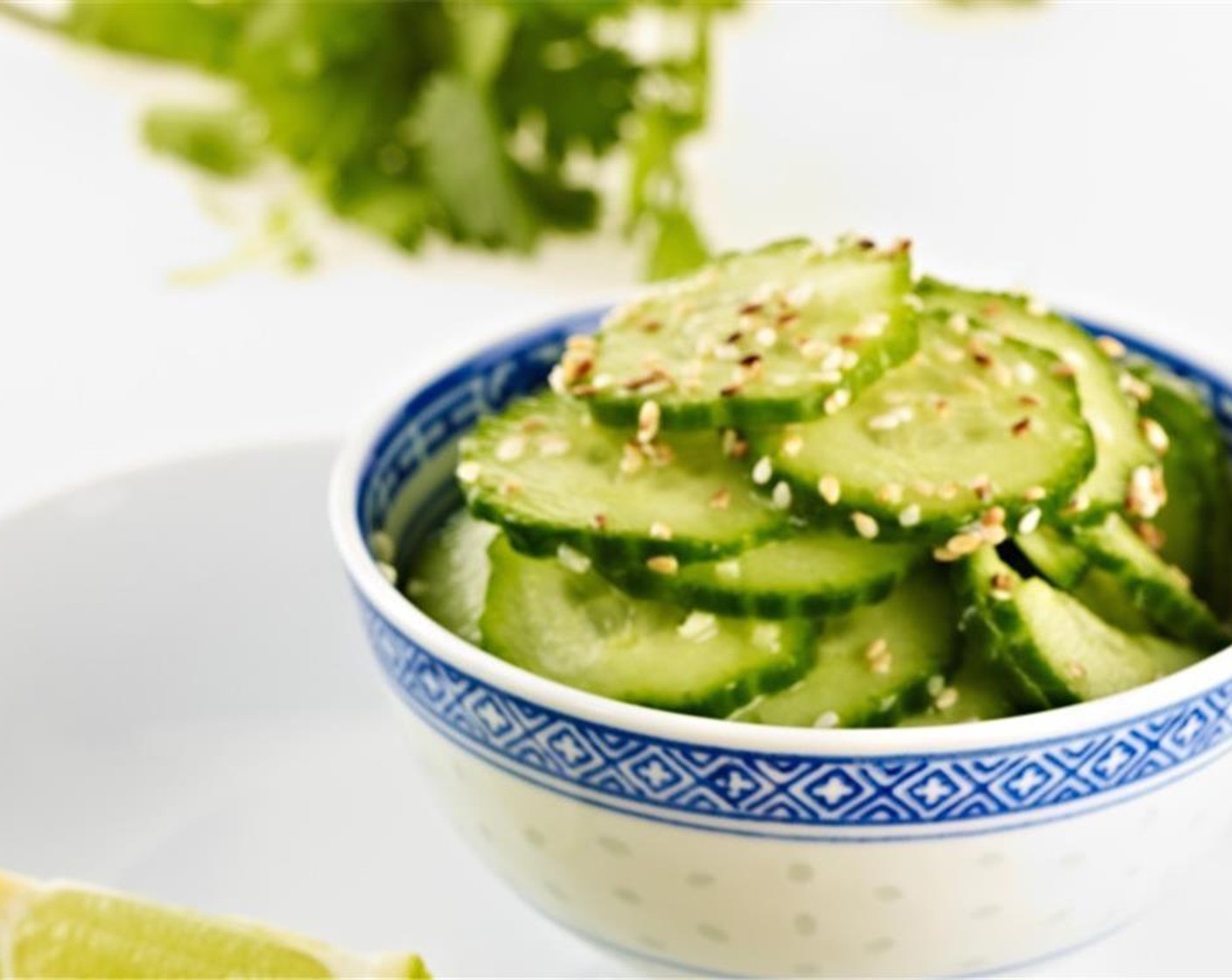 step 6 Finely slice the Cucumber (1)) and chop Fresh Ginger (1 tsp). Toss in a bowl with Sesame Oil (2 tsp), Sweet Rice Vinegar (2 Tbsp), Rice Vinegar (2 Tbsp), and Toasted White Sesame Seeds (1 tsp), Salt (to taste), and Ground Black Pepper (to taste). Marinate for at least 5 minutes.