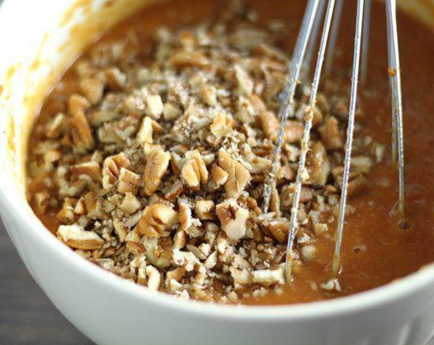 step 4 In a separate bowl, whisk together Canned Pumpkin Pie Mix (2 cups), Eggs (3), Vegetable Oil (2/3 cup), Orange Extract (1/2 tsp), and juice from Lemon (1). Stir in the Pecans (1 cup).