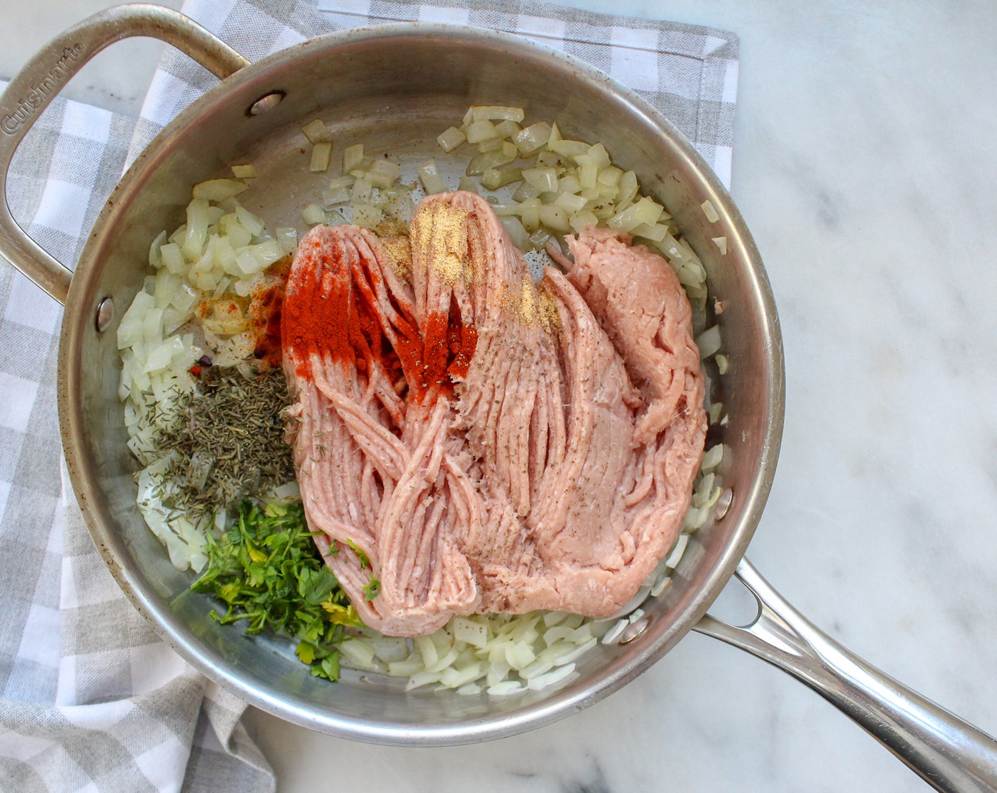 step 1 In a large skillet over medium heat sauté Yellow Onion (1 cup) in Olive Oil (1 Tbsp) until softened, about 3-4 minutes. Add Ground Turkey (1 lb), Dried Parsley (1 tsp), Dried Thyme Leaves (1 tsp), Smoked Paprika (1/2 tsp), Simply Organic Garlic Powder (1/4 tsp), Salt (1/4 tsp), and Ground Black Pepper (1/4 tsp), cooking until meat is brown.
