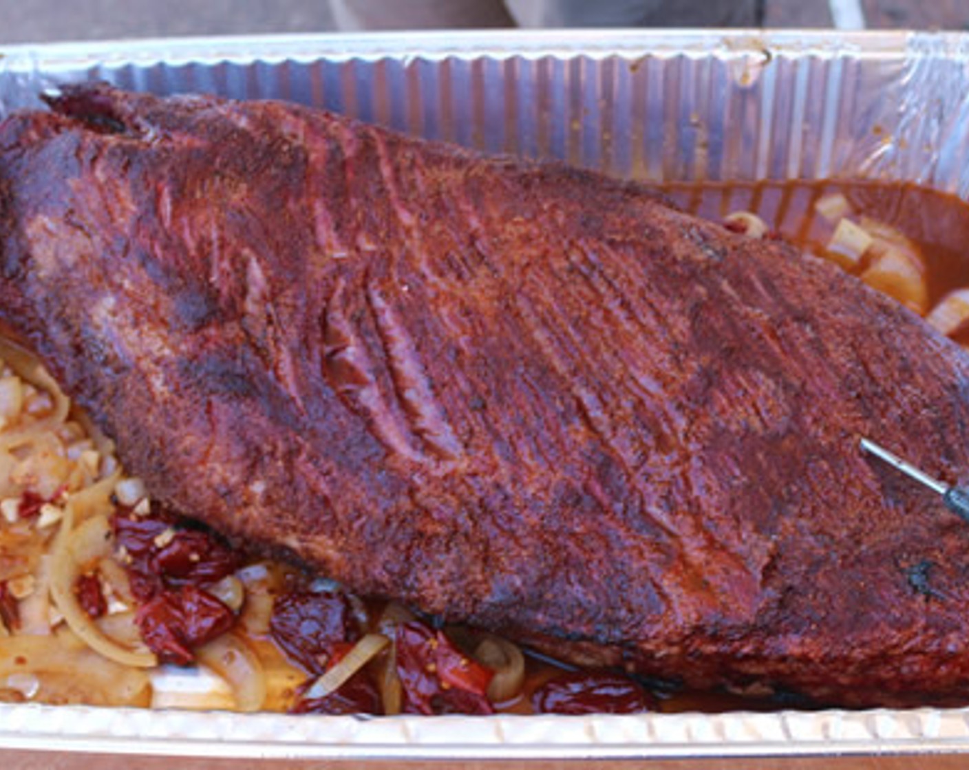 step 8 Place the brisket in a full size aluminum pan and pour in Brisket Jus. Insert a probe thermometer into thickest part of the flat and cover pan with foil. Continue to cook until internal temperature reaches 204 degrees F.