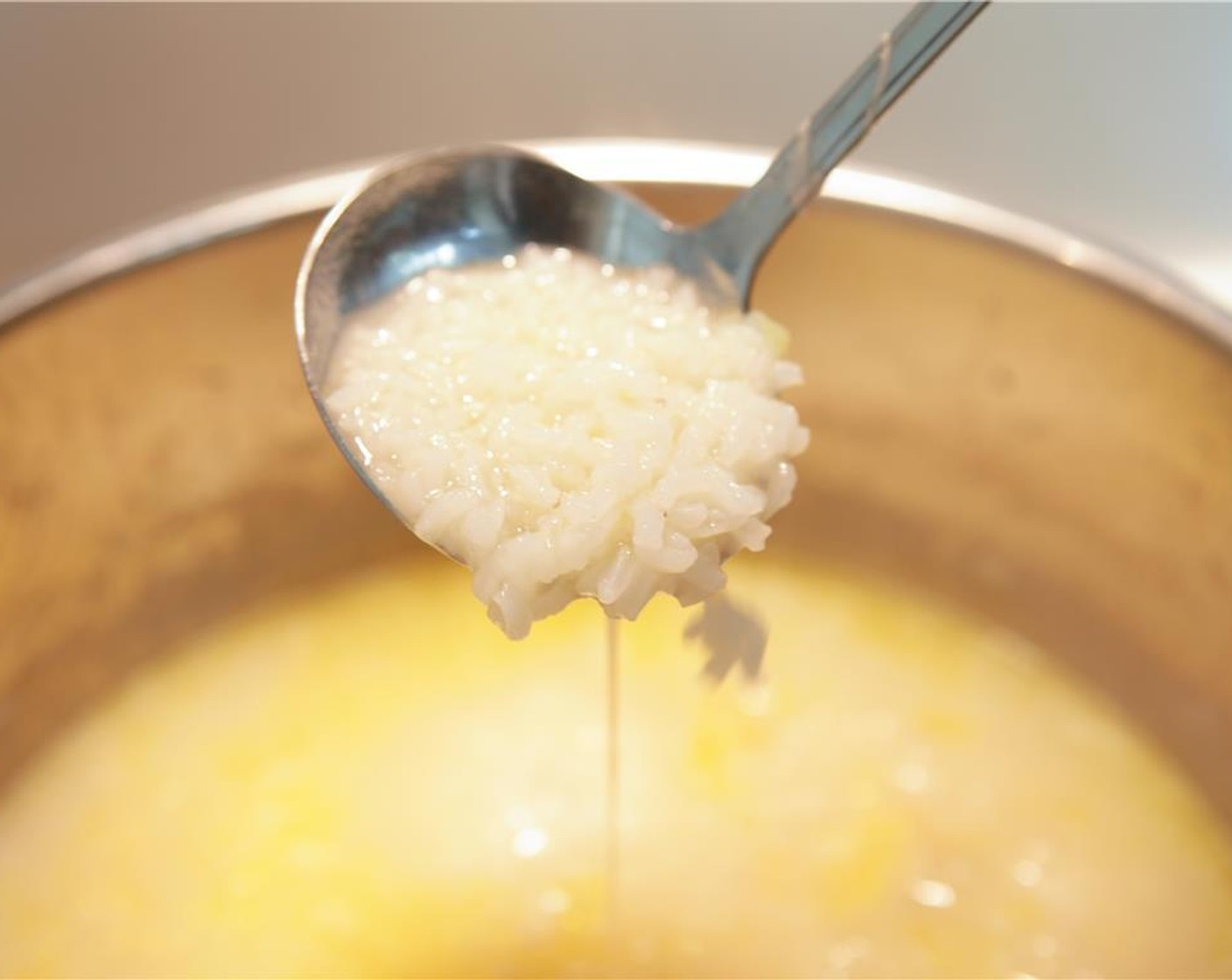 step 3 Remove the chicken onto a plate and leave the onions and ginger in the pot with the broth. Add the Jasmine Rice (1 cup) and simmer for 30 minutes on medium heat. Add the Fish Sauce (1 Tbsp) and season with pepper. Shred some of the chicken and return to the pot.