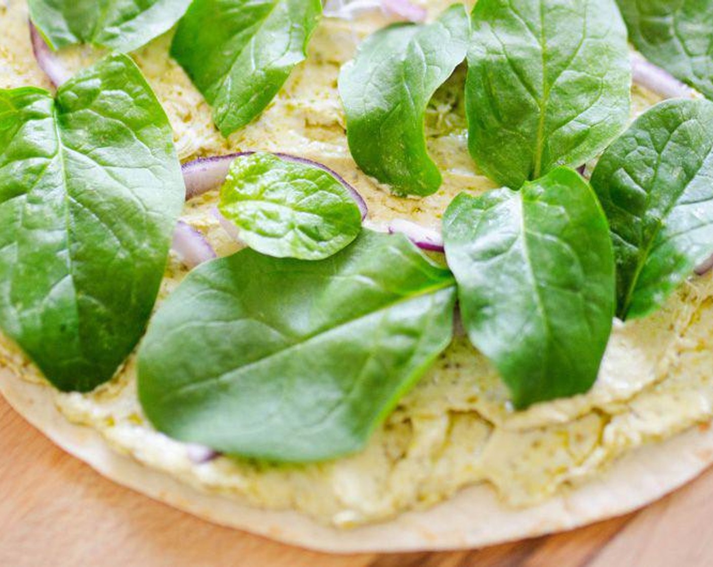 step 1 Combine Light Cream Cheese (3/4 cup) and Basil Pesto (3 Tbsp), then evenly spread over each Large Flour Tortillas (3), leaving 1 inch free on one side of each tortilla.