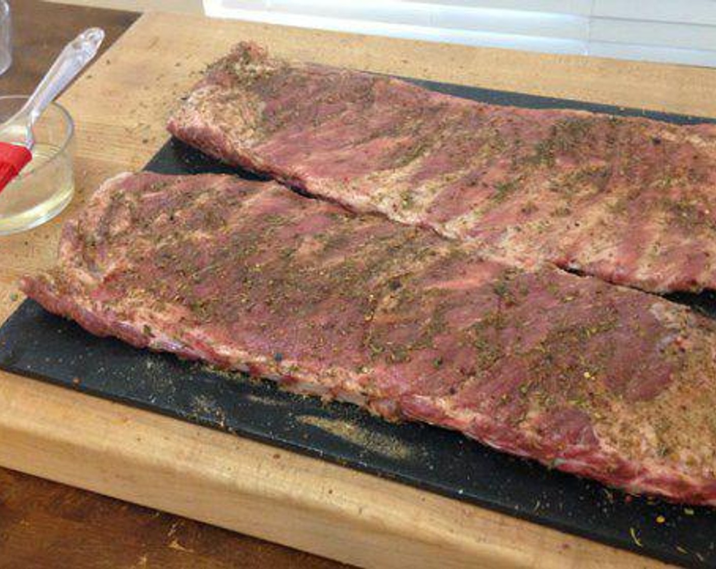 step 4 Sprinkle on the Jerk Seasoning and rub it into the meat. Place the ribs back into the refrigerator to dry marinate for 1-2 hrs.