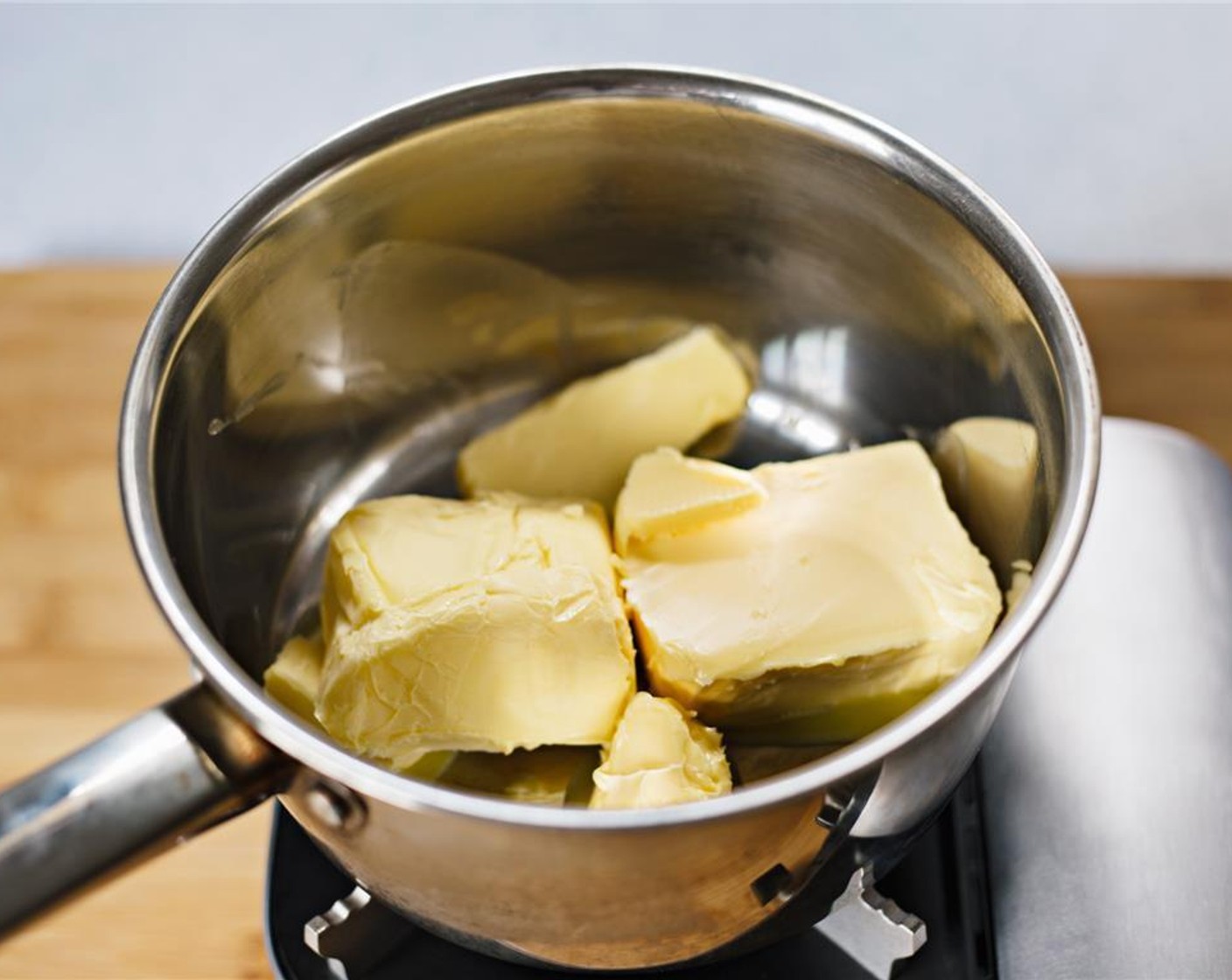 step 1 Add Unsalted Butter (1 cup) to a saucepan, and melt over low heat.