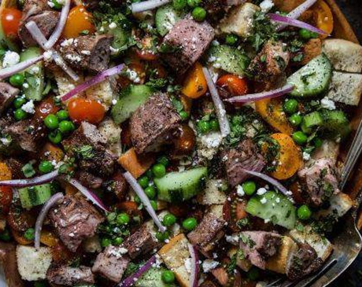 step 10 Next, take the cooled lamb steaks and cut them into one-inch cubes. Place the cubes on the salad along with Feta Cheese (to taste).