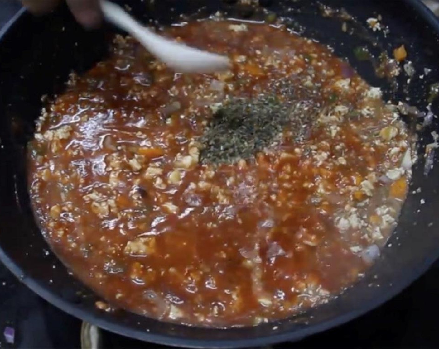 step 12 Sprinkle in Dried Basil (1/2 Tbsp). Bring it to a boil and add the tomatoes. Simmer for a minute or two. Turn off the heat and set aside.