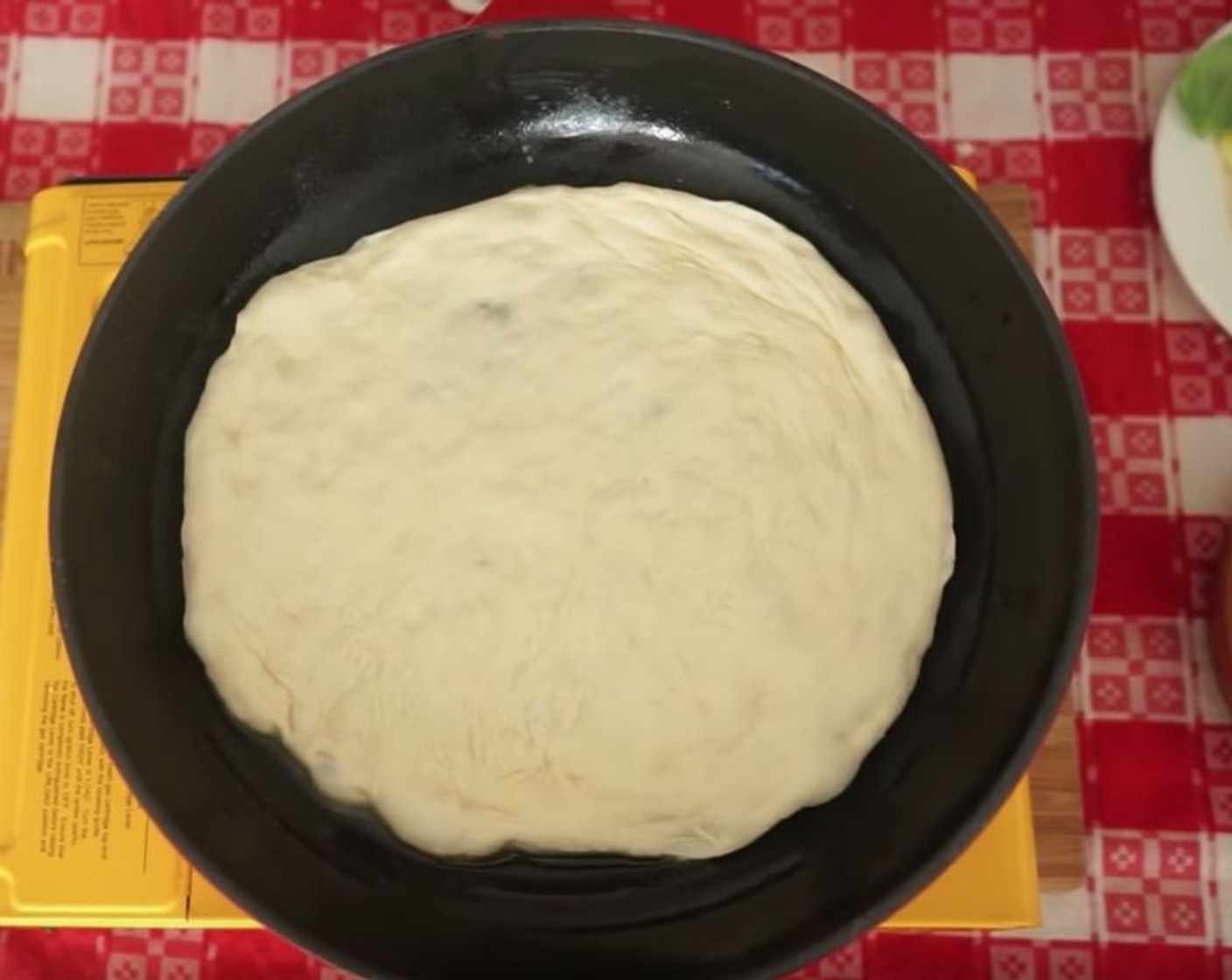 step 12 Turn the heat down on the stove and place the pizza in the pan, stretching it out just enough so that it fits.