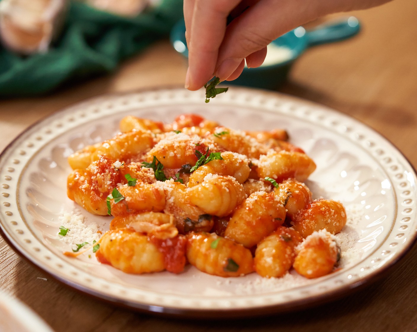 step 6 Serve on the plate with more parmesan cheese on top. Garnish with basil leaves.