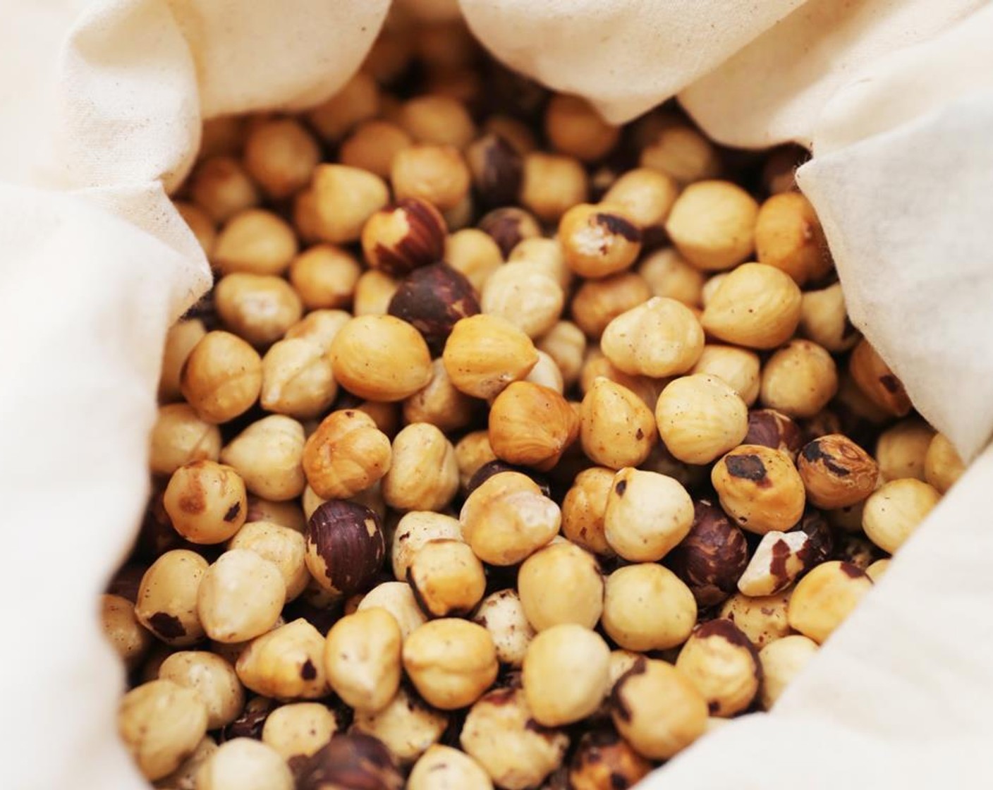 step 3 Remove from oven and let cool slightly. Transfer to a large kitchen towel and use your hands to move the nuts around to loosen their skins. Remove all the skins.