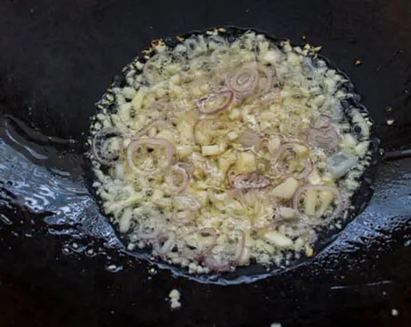 step 1 Heat Cooking Oil (3 Tbsp) in a wok over medium-high heat. Add Garlic (3 cloves) and Shallots (3) to the oil as it heats up.