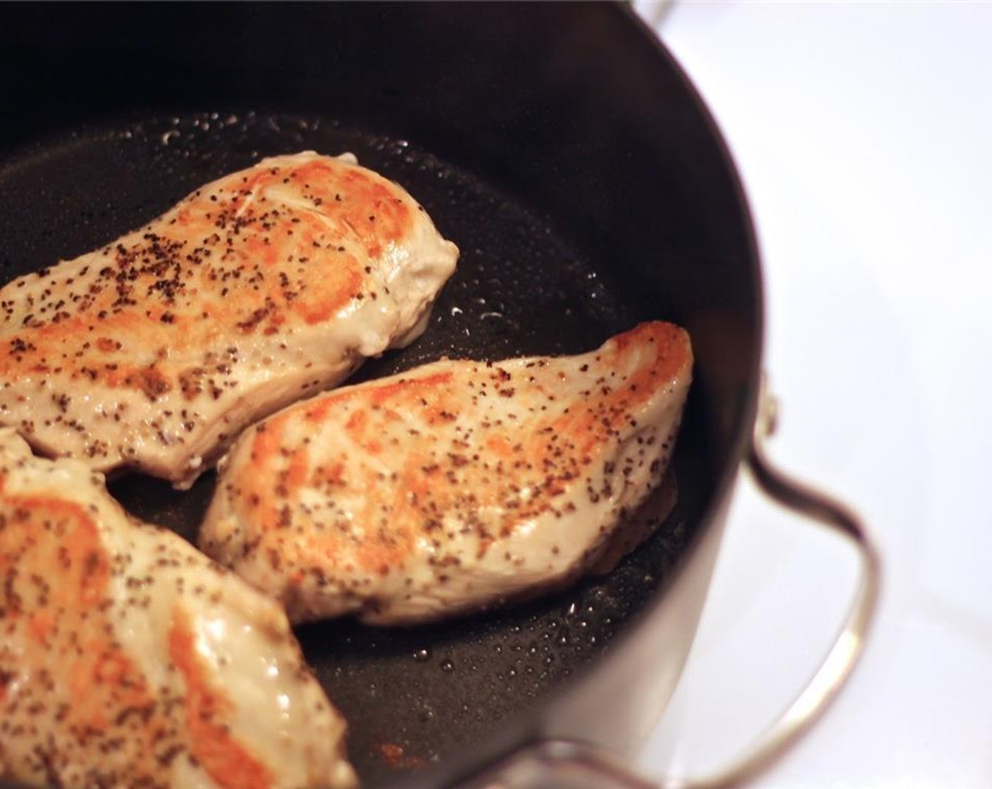 step 5 Heat a large pot above a high flame and add Olive Oil (1 Tbsp). Once hot, season the Chicken Breasts (3) with Salt (1 tsp) and Ground Black Pepper (1 tsp) and sear them in the pot on both sides, until browned. Remove from the pot and set aside.